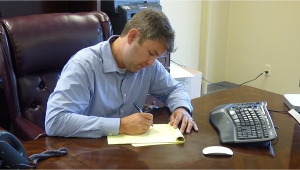 Photo of attorney David Christoffel working at his desk