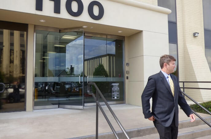 Photo of attorney David Christoffel walking out of his office building